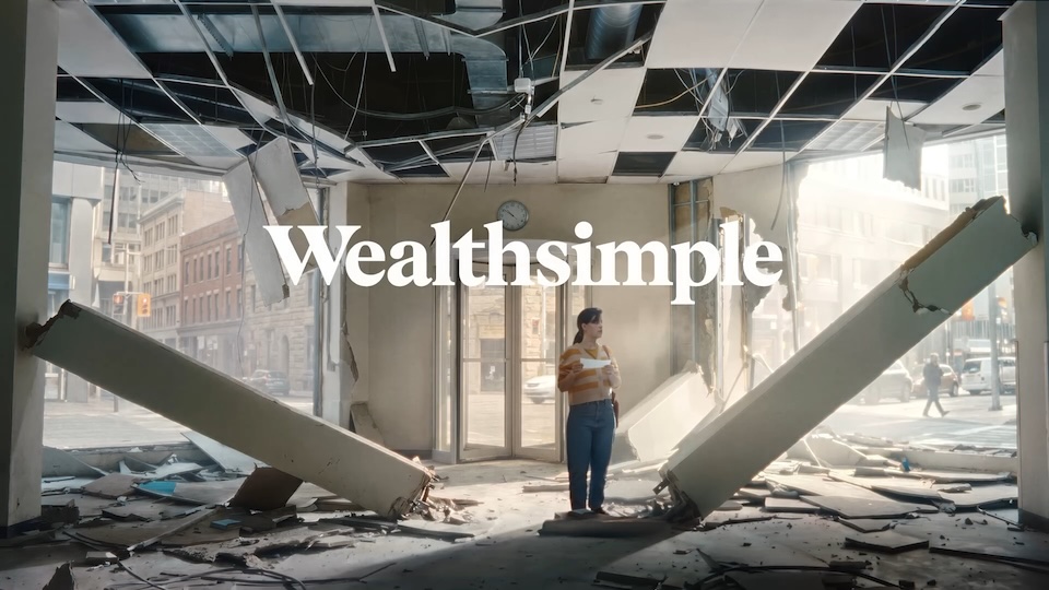 WEALTH | Muse by Clios Woman stands in a destroyed office with a collapsed ceiling and rubble, city street visible outside, Wealthsimple logo overlaid.”