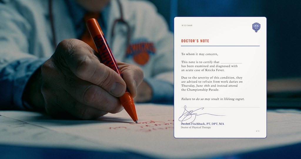 Close-up of a hand signing with an orange marker on paper; blurred medical scrubs in the background with a Doctor's Note card nearby.