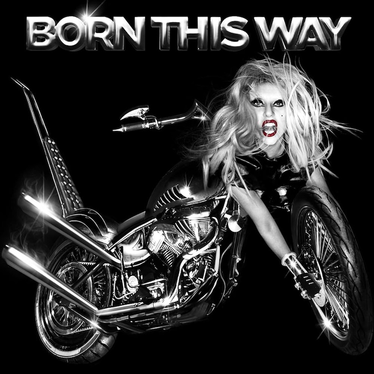 Born This Way Lady Gaga | Muse by Clios Black-and-white promotional image of a fierce woman riding a chrome motorcycle, mouth open in a scream, with'BORN THIS WAY' text above.