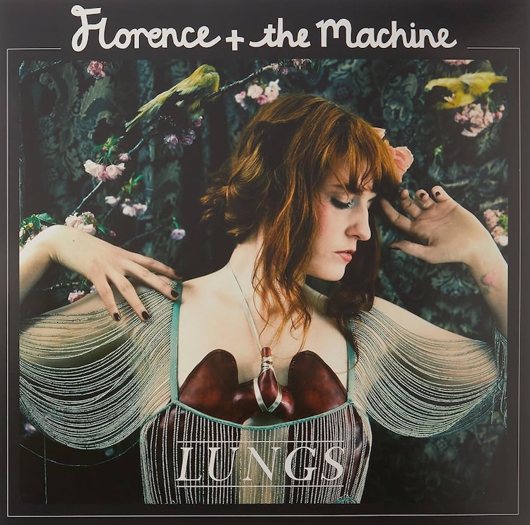 Lungs Florence + The Machina | Muse by Clios Album cover for Florence + the Machine's Lungs: Florence Welch with red hair in a decorative fringe dress against a floral backdrop, hands raised near her head.
