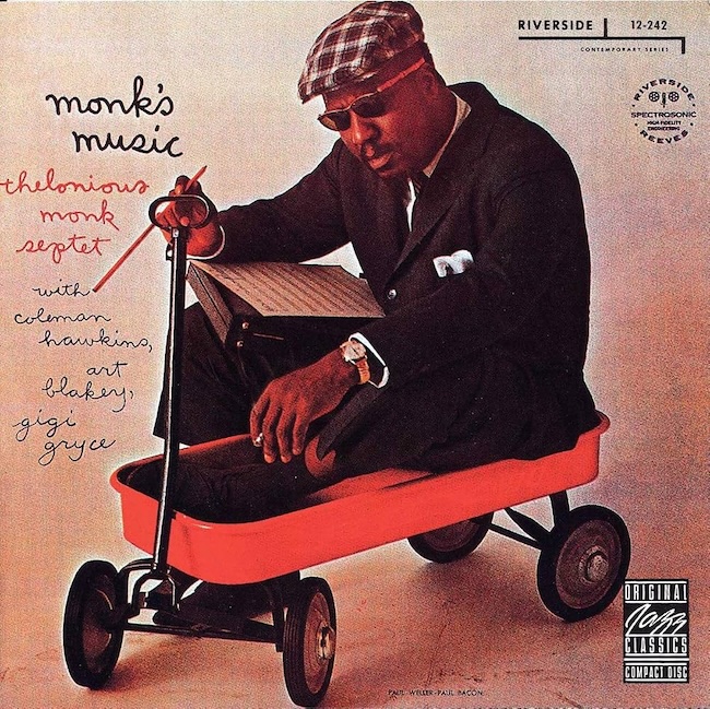 Album cover for Thelonious Monk's music: Monk in a suit and cap sits in a red wagon, reading sheet music.