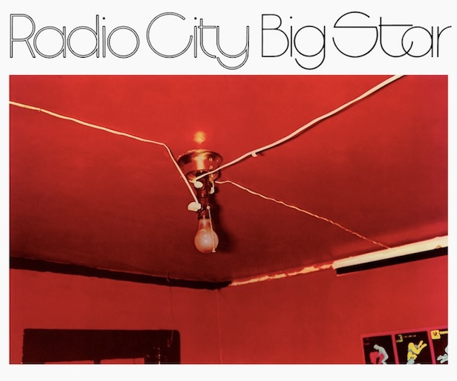 Red room ceiling with an exposed light bulb and tangled wires; 'Radio City Big Star' text appears at the top.