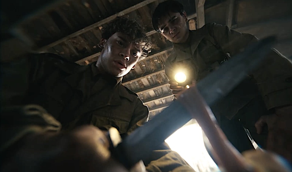 Screenshot | Muse by Clios Two soldiers in uniform shine a flashlight on a person lying on the floor in a dim attic space.