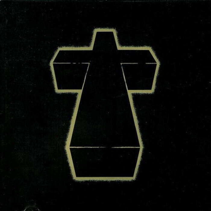 Outline of a cross-shaped 3D prism in pale yellow on a black background.