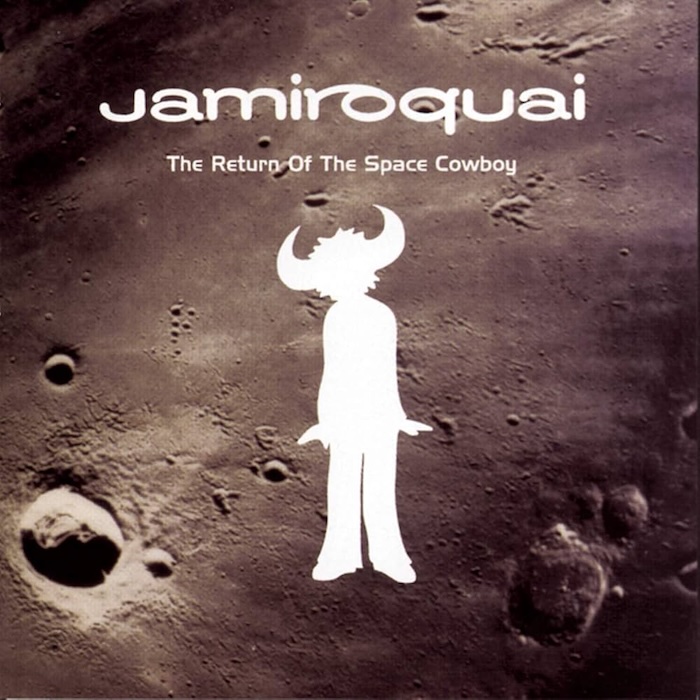 Album cover for Jamiroquai's The Return Of The Space Cowboy featuring a white horned silhouette on a lunar crater background.