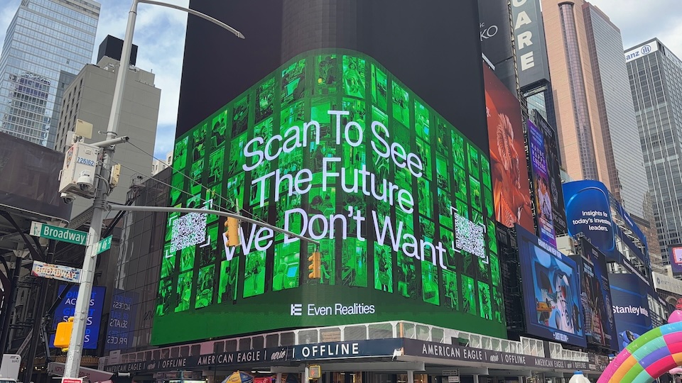 exposed 3 | Muse by Clios Green digital billboard in Times Square displaying 'Scan To See The Future We Don’t Want' with a Broadway street sign nearby.